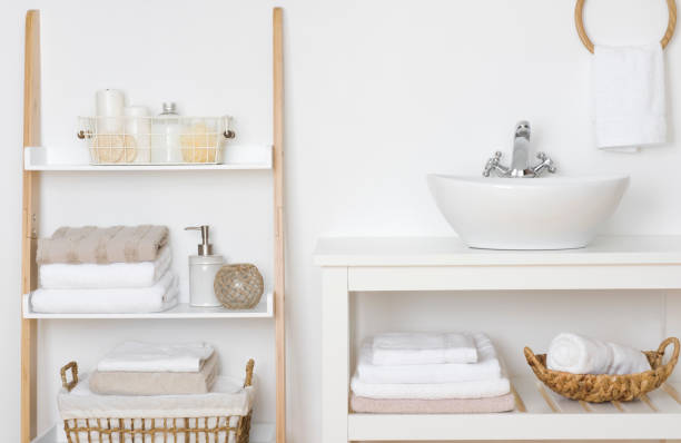 Bathroom shelves with towels and spa products in light interior